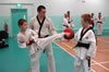 James Byrne helping a high grade student on the intricacies of the reverse turning kick (Bandae Dollyo Chagi).